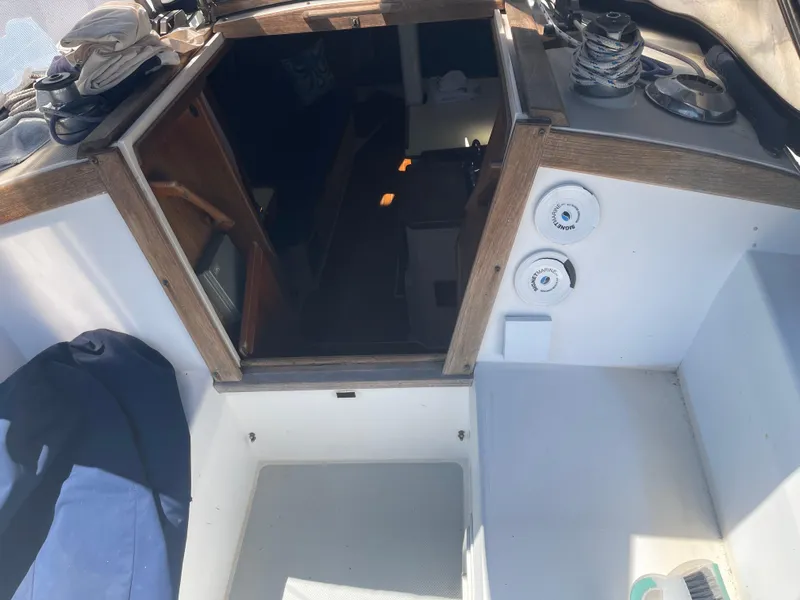 Slide: The Image of Interior view of a 1986 Catalina 34 sailboat cockpit with wooden trim and nautical equipment. - 37