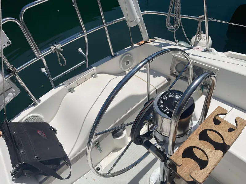 Slide: The Image of Steering wheel and compass on a 1986 Catalina 34 sailboat deck. - 38