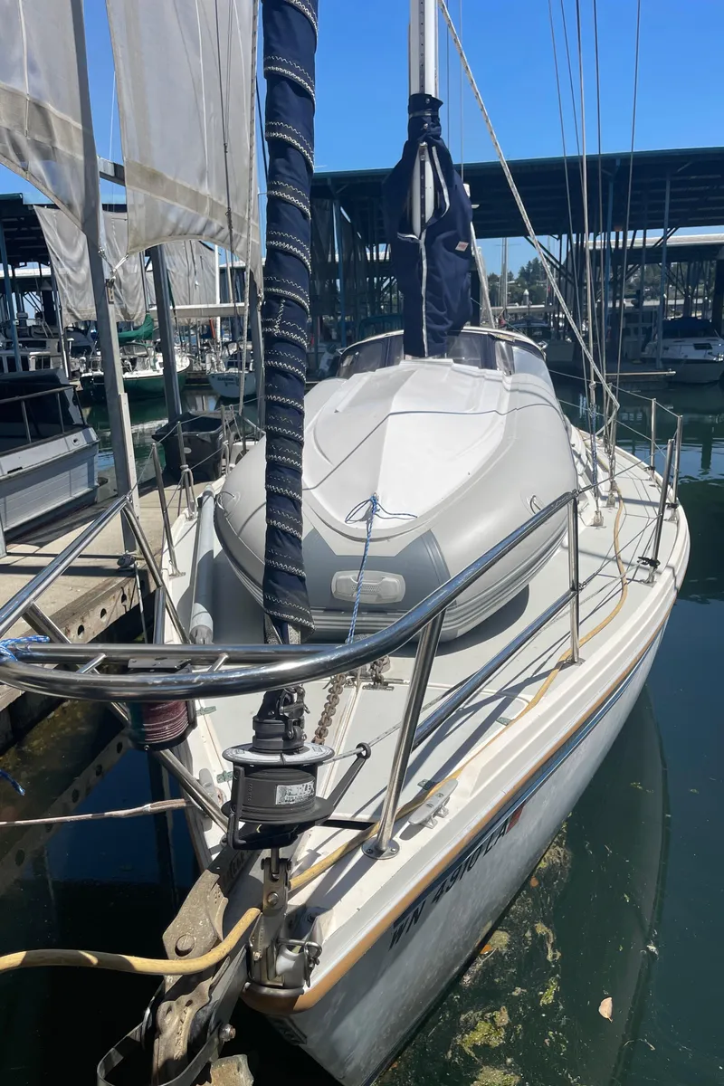 Slide: The Image of 1986 Catalina 34 sailboat docked at marina, featuring sleek design and rigging. - 42