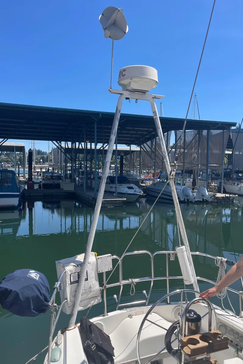 Slide: The Image of 1986 Catalina 34 sailboat docked at marina under clear blue sky. - 43