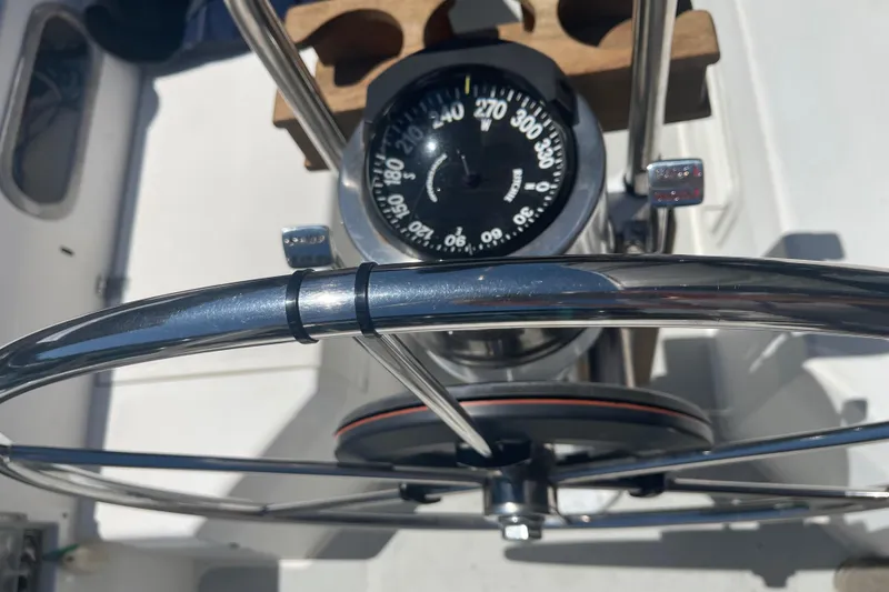 Slide: The Image of Steering wheel and compass on a 1986 Catalina 34 sailboat. - 45