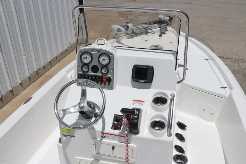 Slide: The Image of 2011 Sea Hunt XP-21 boat dashboard with steering wheel and gauges. - 15