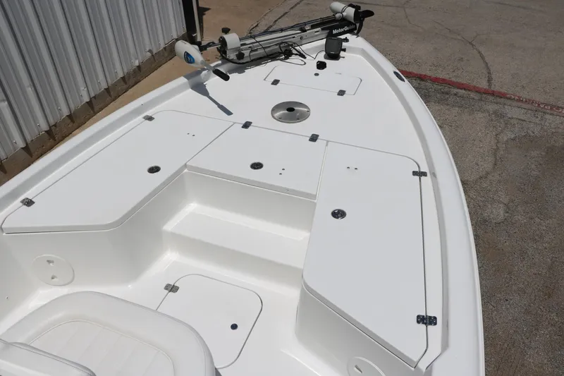 Slide: The Image of 2011 Sea Hunt XP-21 boat deck with storage compartments and trolling motor. - 17