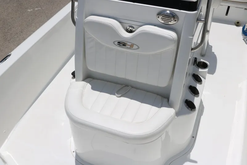 Slide: The Image of White cushioned seat on 2011 Sea Hunt XP-21 boat, featuring rod holders and sleek design. - 21