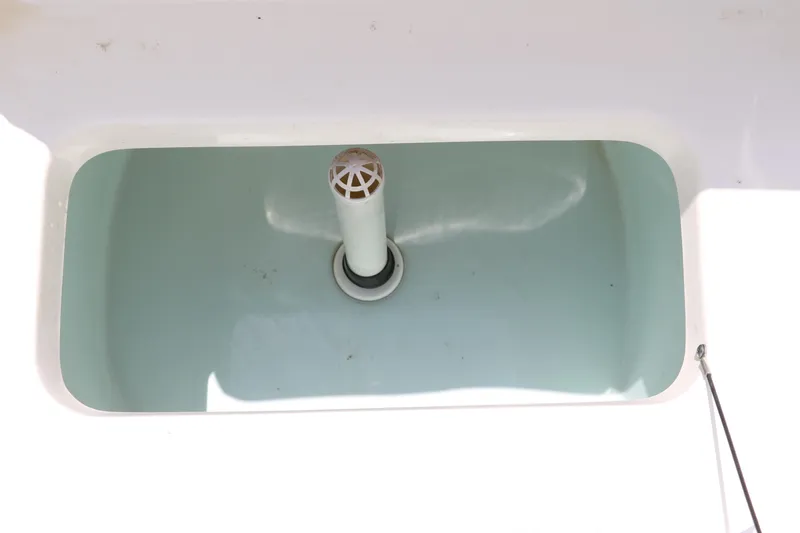Slide: The Image of Sea Hunt XP-21 boat livewell, 2011 model, white interior with drain pipe. - 22