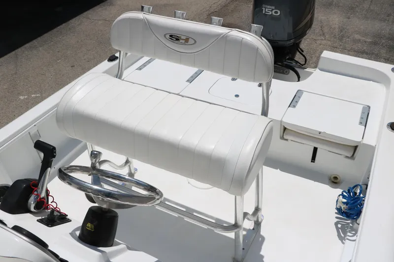 Slide: The Image of 2011 Sea Hunt XP-21 boat interior with white seating and Yamaha 150 engine. - 24