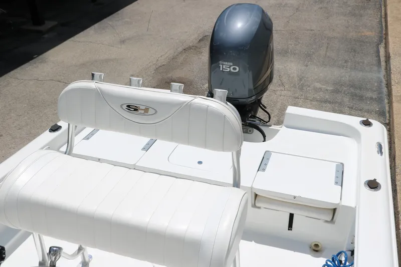 Slide: The Image of 2011 Sea Hunt XP-21 boat with Yamaha 150 engine, featuring white seating and deck. - 25