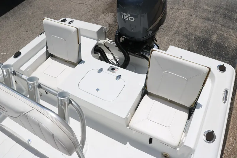 Slide: The Image of 2011 Sea Hunt XP-21 boat interior with Yamaha 150 engine, featuring white seating and rod holders. - 26