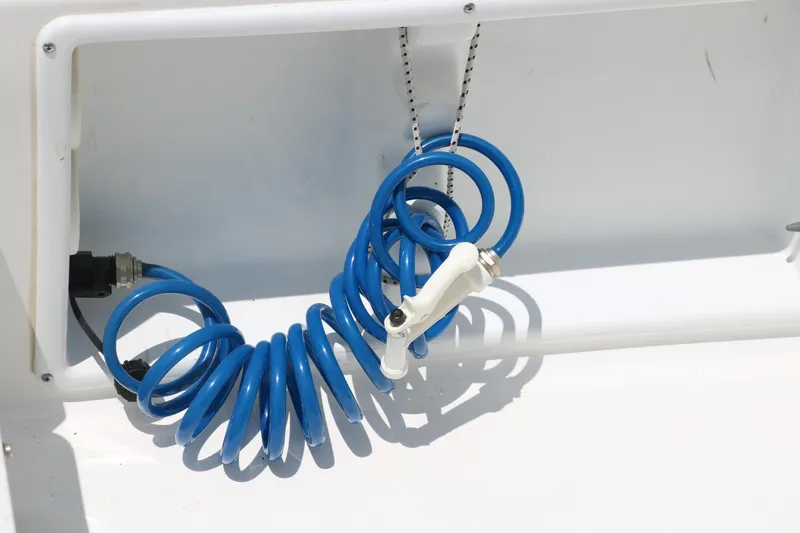 Slide: The Image of Blue coiled hose in a Sea Hunt XP-21 boat, 2011 model. - 32