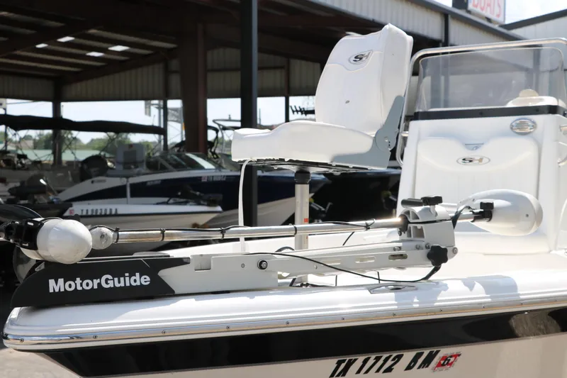 Slide: The Image of 2011 Sea Hunt XP-21 boat with MotorGuide trolling motor in a marina setting. - 39