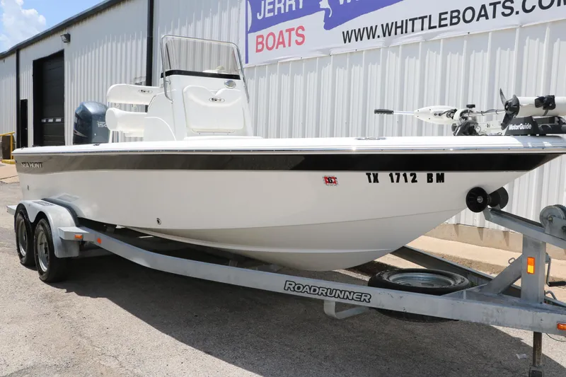 Slide: The Image of 2011 Sea Hunt XP-21 boat on trailer, parked outside a dealership. - 5