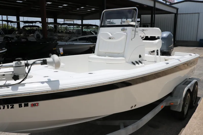 Slide: The Image of 2011 Sea Hunt XP-21 boat on trailer in marina setting. - 7