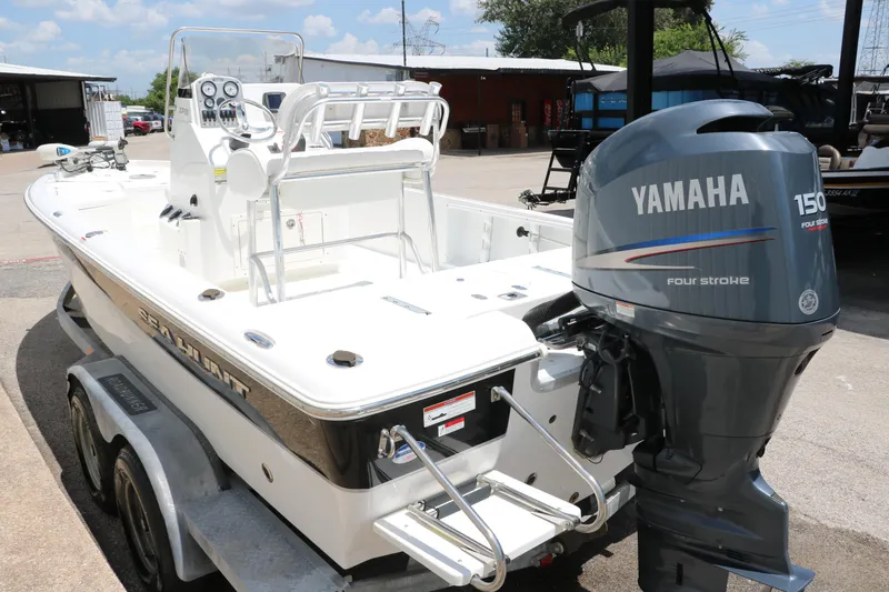 Slide: The Image of 2011 Sea Hunt XP-21 boat with Yamaha 150 four-stroke engine, parked on a trailer. - 8