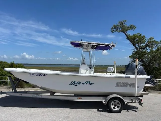 Slide: The Image of 2008 Carolina Skiff 218DLV boat on trailer, parked near scenic waterfront. - 1