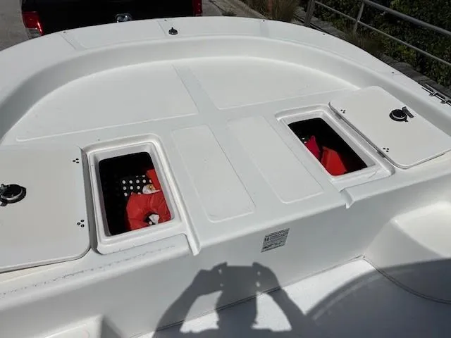 Slide: The Image of 2008 Carolina Skiff 218 DLV boat with blue T-top and metal frame. - 13