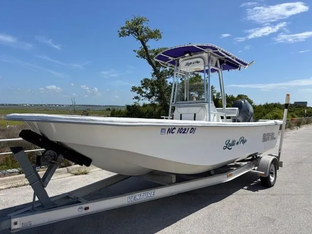 Slide: The Image of 2008 Carolina Skiff 218DLV boat on trailer under clear blue sky. - 2