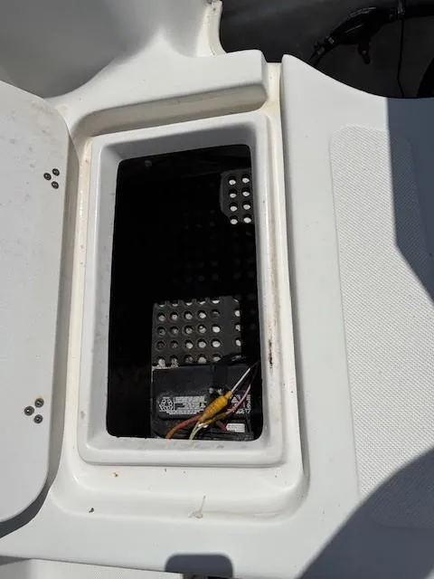 Slide: The Image of Open storage compartment in a 2008 Carolina Skiff 218DLV boat, showing internal wiring. - 28