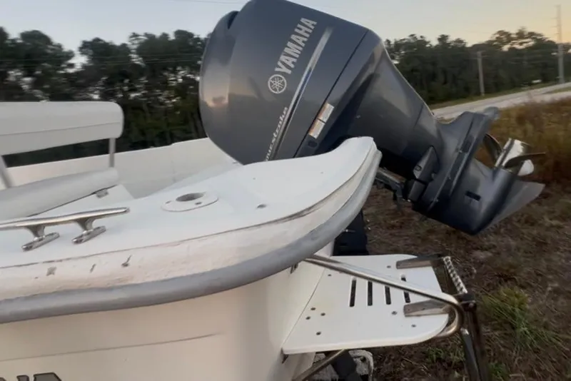 Slide: The Image of 2008 Carolina Skiff 218 DLV boat with Yamaha outboard motor, parked outdoors. - 31