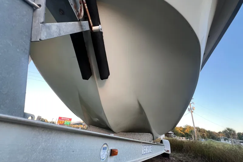 Slide: The Image of 2008 Carolina Skiff 218 DLV boat on trailer, viewed from below, with clear sky background. - 35