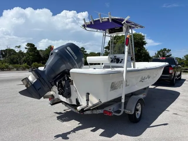 Slide: The Image of 2008 Carolina Skiff 218DLV boat on trailer with Yamaha outboard motor, parked outdoors. - 5