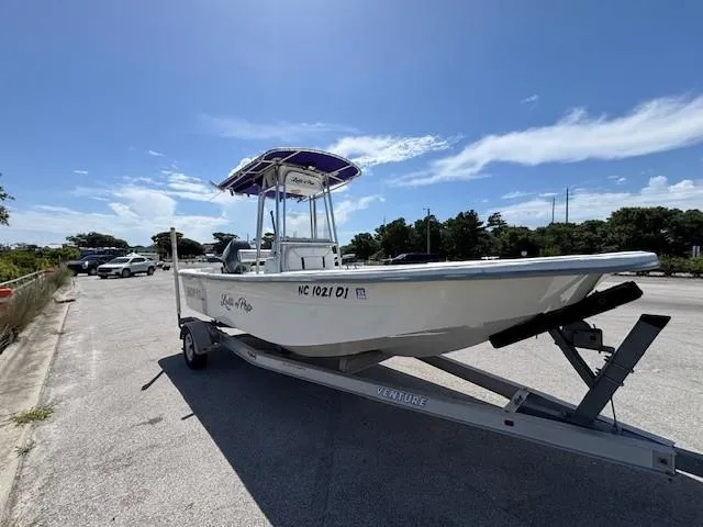 Slide: The Image of 2008 Carolina Skiff 218DLV boat on trailer under clear blue sky. - 7