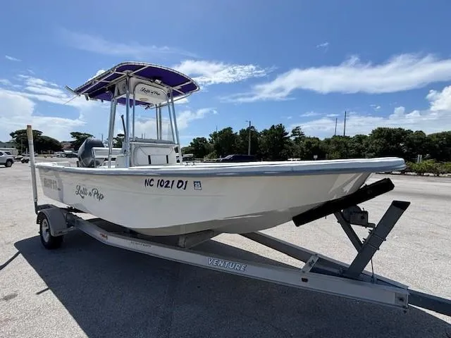 Slide: The Image of 2008 Carolina Skiff 218DLV boat on trailer under clear blue sky. - 8
