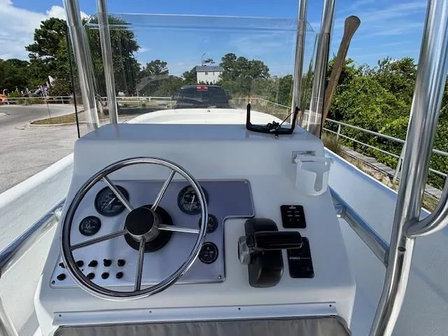 Slide: The Image of 2008 Carolina Skiff 218 DLV boat on trailer, labeled "Lolli n Pop," for sale. - 9