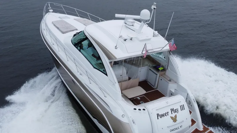 Slide: The Image of 2008 Formula 45 Yacht cruising on open water, rear view with American flag. - 13