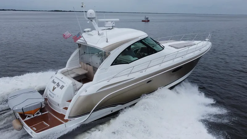 Slide: The Image of 2008 Formula 45 Yacht cruising on open water, displaying sleek design and American flags. - 14