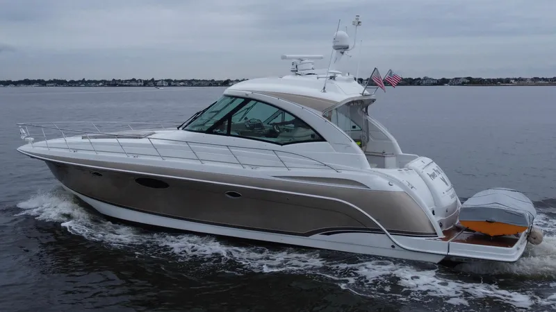 Slide: The Image of 2008 Formula 45 Yacht cruising on calm waters, featuring sleek design and American flags. - 19