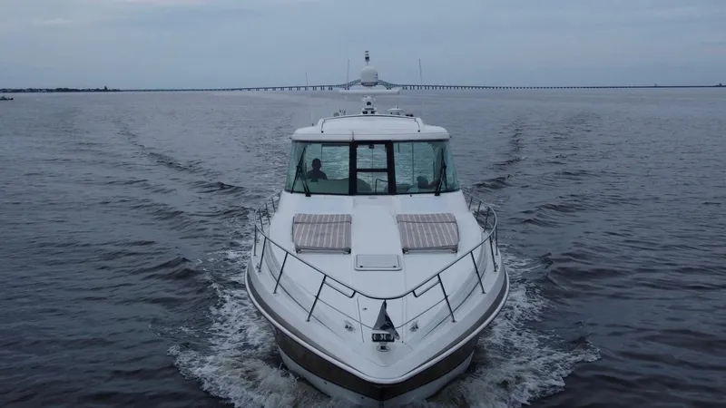 Slide: The Image of 2008 Formula 45 Yacht cruising on open water with distant bridge in background. - 22