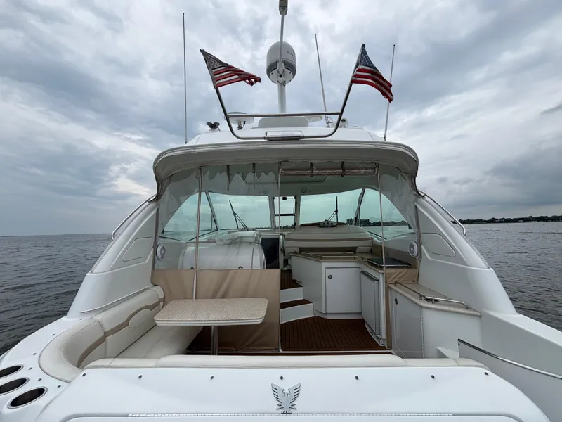 Slide: The Image of 2008 Formula 45 Yacht on water, featuring spacious deck and American flags. - 27
