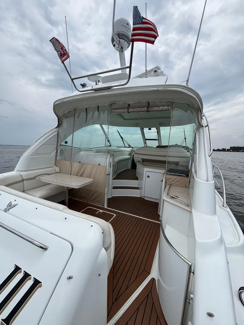 Slide: The Image of 2008 Formula 45 Yacht with American flags, featuring spacious deck and seating area. - 28