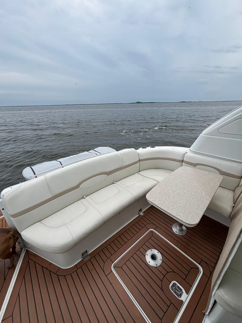 Slide: The Image of 2008 Formula 45 Yacht deck with white seating and table, overlooking calm waters. - 30