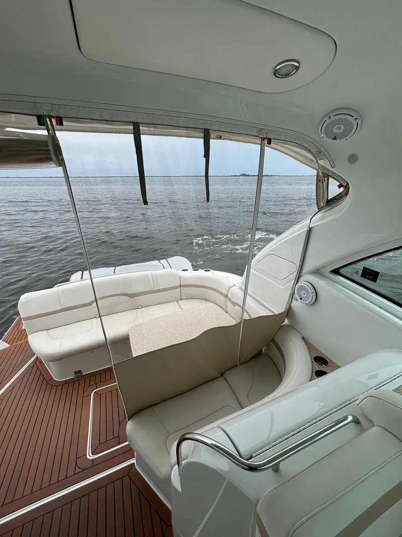 Slide: The Image of 2008 Formula 45 Yacht interior with white seating and wooden deck, overlooking calm waters. - 31