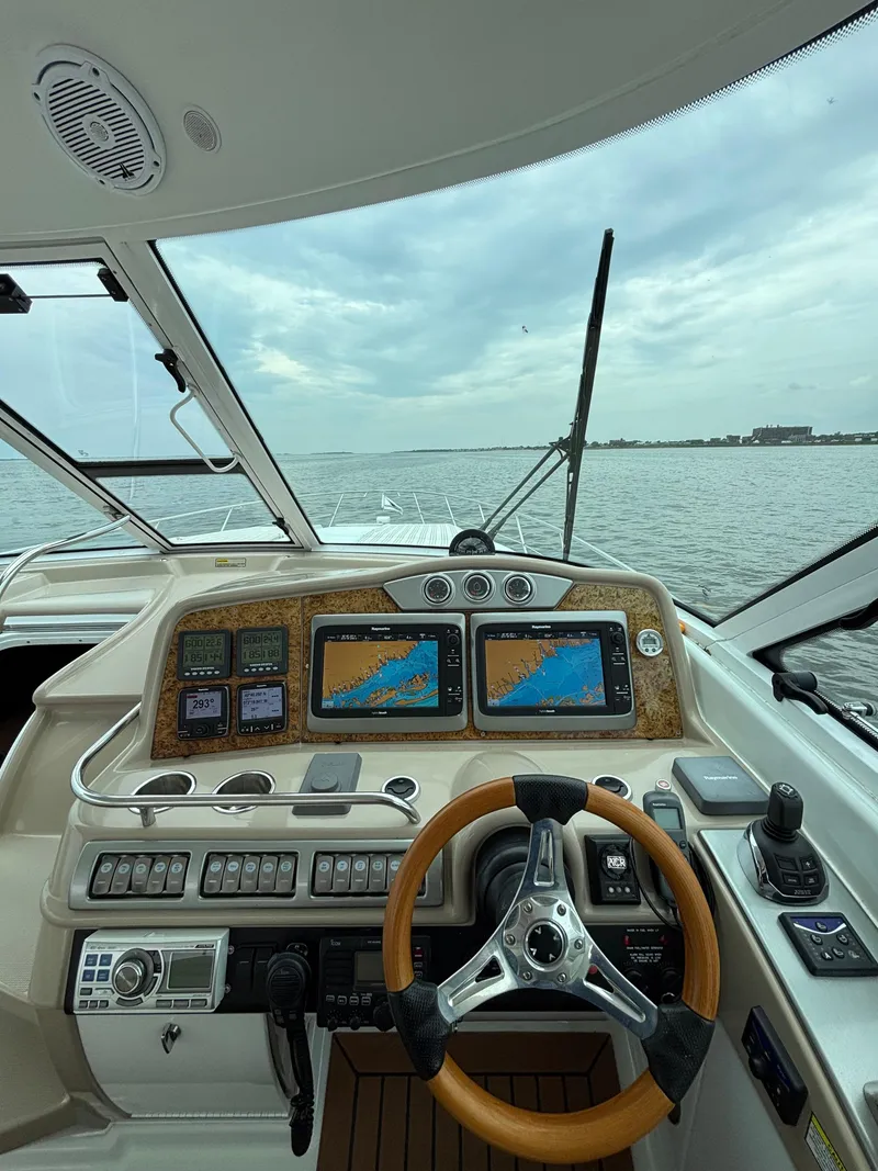 Slide: The Image of Control panel of a 2008 Formula 45 Yacht with navigation screens and steering wheel. - 36