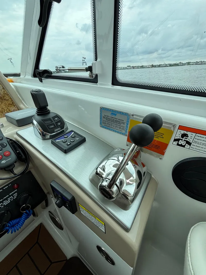 Slide: The Image of Control panel of a 2008 Formula 45 Yacht with throttle and joystick. - 41