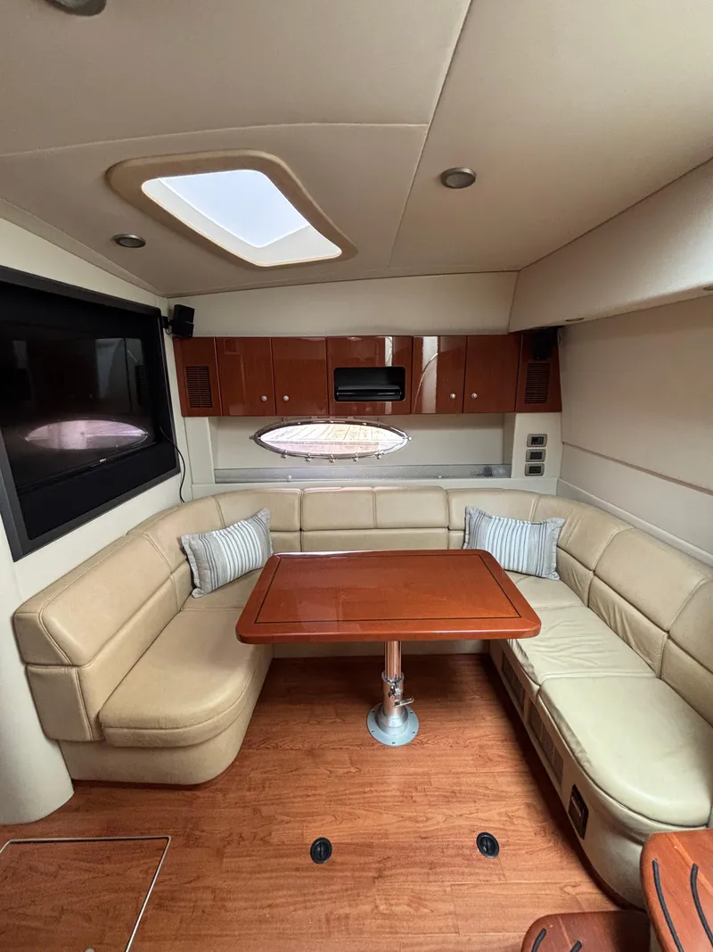 Slide: The Image of Luxurious interior of a 2008 Formula 45 Yacht with beige seating and wooden table. - 49