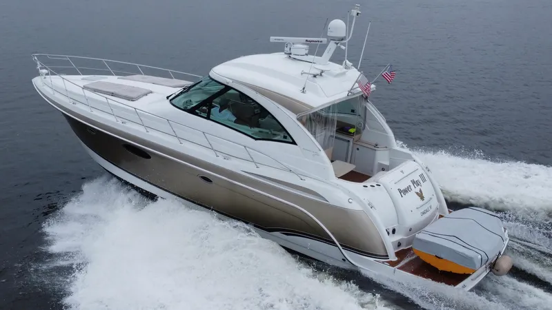 Slide: The Image of 2008 Formula 45 Yacht cruising on open water, rear view with American flags. - 5