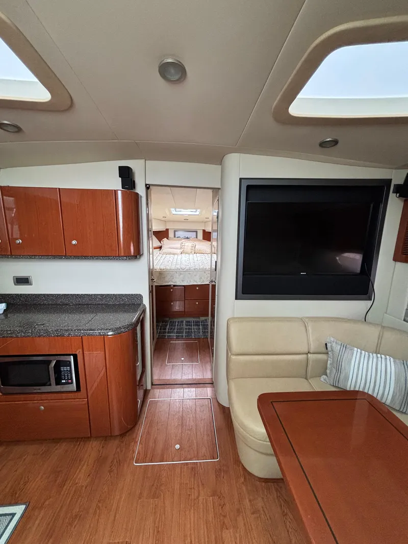 Slide: The Image of Interior of 2008 Formula 45 Yacht with modern kitchen, seating, and bedroom view. - 50