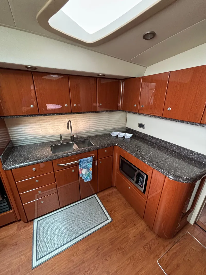 Slide: The Image of Luxurious kitchen interior of 2008 Formula 45 Yacht with wood cabinets and modern appliances. - 52