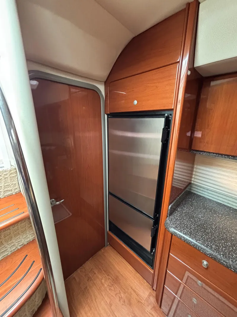Slide: The Image of Interior of 2008 Formula 45 Yacht with wood cabinetry and stainless steel fridge. - 54