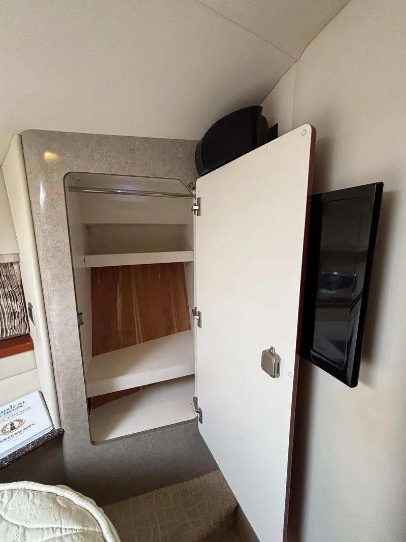 Slide: The Image of Interior of 2008 Formula 45 Yacht showing open cabinet and wall-mounted TV. - 58