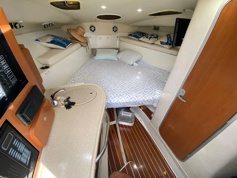 Slide: The Image of 2006 Hydra-Sports Vector 3300 VX cabin interior with bed, sink, and wooden flooring. - 14