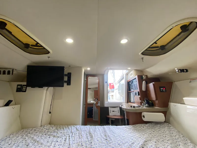 Slide: The Image of Interior of 2006 Hydra-Sports Vector 3300 VX boat with bed, TV, and kitchenette. - 16