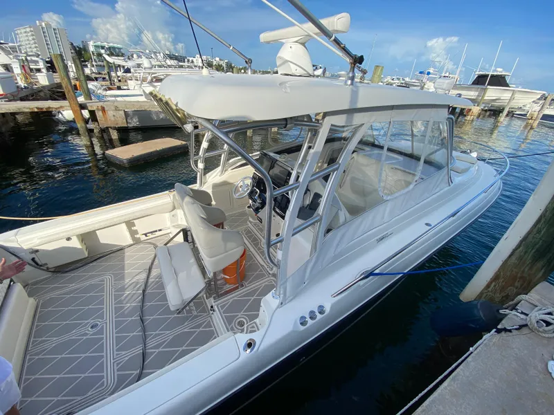 Slide: The Image of 2006 Hydra-Sports Vector 3300 VX boat docked at marina, featuring spacious seating and canopy. - 20