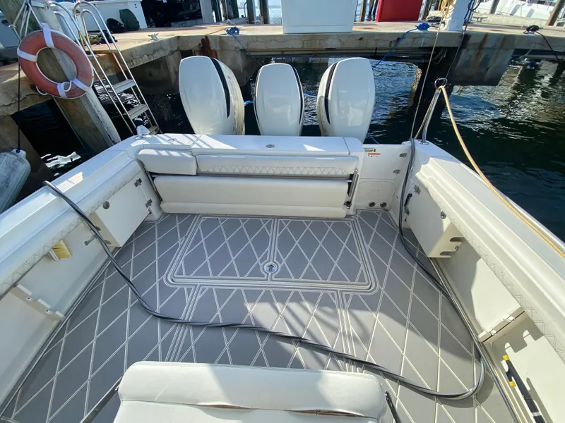 Slide: The Image of 2006 Hydra-Sports Vector 3300 VX boat interior with triple outboard engines at dock. - 24