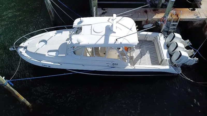 Slide: The Image of 2006 Hydra-Sports Vector 3300 VX boat docked, aerial view, featuring twin outboard engines. - 9