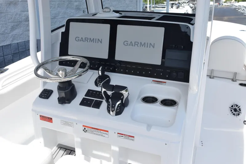 Slide: The Image of 2026 Sea Hunt Gamefish 27 console with Garmin displays and steering wheel. - 10