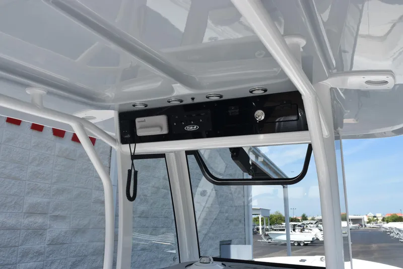 Slide: The Image of 2026 Sea Hunt Gamefish 27 Forward Seating boat console with electronics and storage. - 11